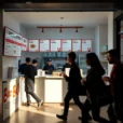 Editorial photograph inside a new Bao Fast Foods location in east London, late afternoon light falling.