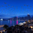 Editorial photograph in Taipei during COMPUTEX and InnoVEX at blue hour: thousands of drones forming abstract.