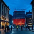 Editorial photograph of Smithfield in London at blue hour, with the historic market buildings and construction.