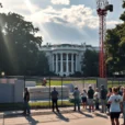 Editorial photograph outside the presidential residence in Washington, DC, showing construction fencing, a tower crane.
