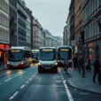 Editorial photograph of a dense European city street at early morning, showing a protected cycle lane.