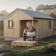 Editorial photograph of a modest, approximately 42-square-metre timber house with a simple pitched roof on.