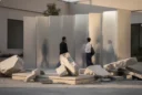 Editorial photograph of a temporary architectural installation in Tehran, with salvaged concrete fragments arranged beside reflective.