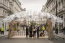 Editorial photograph on the pedestrianised Strand in London during London Design Festival: a temporary bamboo-grid pavilion.