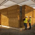 Editorial photograph concept of a compressed-straw building-system mock-up at a New York construction research site, without.