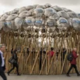 Editorial photographic interpretation of a temporary bamboo pavilion topped with police shields on the Strand, central.