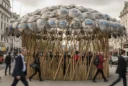 Editorial photographic interpretation of a temporary bamboo pavilion topped with police shields on the Strand, central.