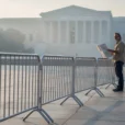 Editorial photograph of an existing civic pedestrian space in Washington DC at dawn, temporary metal security.