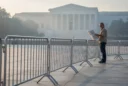Editorial photograph of an existing civic pedestrian space in Washington DC at dawn, temporary metal security.