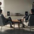 Editorial photograph imagining a domestic listening scene inside a furniture showroom in Farringdon, London, during London.