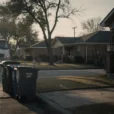 Illustrative editorial photograph on a residential street in Dallas, Texas, at early morning collection time..