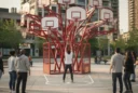 Editorial photograph of an outdoor public art setting in Toronto, a branching red sculpture carrying more.