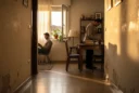 Editorial photograph inside a modest apartment in Vicálvaro, Madrid, representative rather than a reconstruction of.