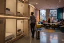 Illustrative editorial photograph inside a capsule hotel in Soho, central London, showing the threshold between.