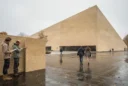 Editorial photograph of a contemporary wedge-shaped cultural building in Eindhoven, its hempcrete envelope finished with earthy.