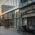 Editorial street photograph in Tokyo’s Yaesu district, looking along a busy pavement where a contemporary office.