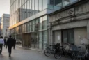 Editorial street photograph in Tokyo’s Yaesu district, looking along a busy pavement where a contemporary office.