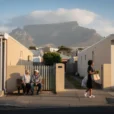 Editorial photograph of a residential street in District Six, Cape Town, with contemporary low-rise homes, ordinary.