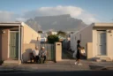 Editorial photograph of a residential street in District Six, Cape Town, with contemporary low-rise homes, ordinary.