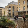 Editorial photograph of contemporary apartment housing in Coulsdon, South London, viewed from a public pavement.