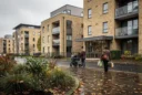 Editorial photograph of contemporary apartment housing in Coulsdon, South London, viewed from a public pavement.