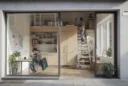 Editorial photograph of a plausible apartment converted from commercial premises, viewed diagonally from its former shopfront..