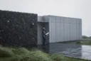 Editorial architectural photograph of a modest coastal home in the Azores, a contemporary prefabricated addition meeting.