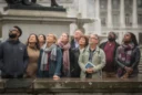 Editorial photograph in Trafalgar Square, London, on an overcast autumn afternoon: a diverse group of visitors.